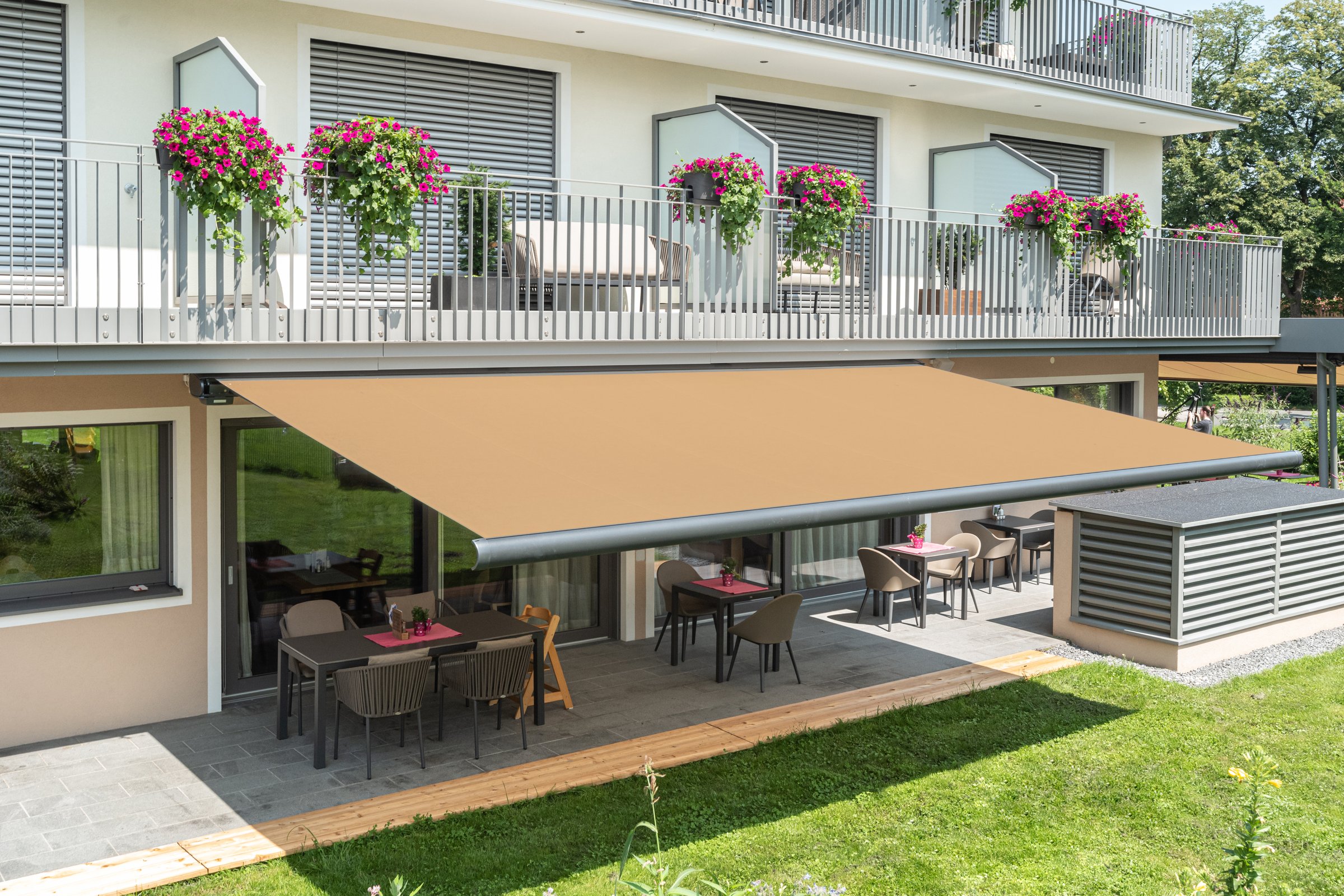 Motorized retractable awning retracted against exterior wall