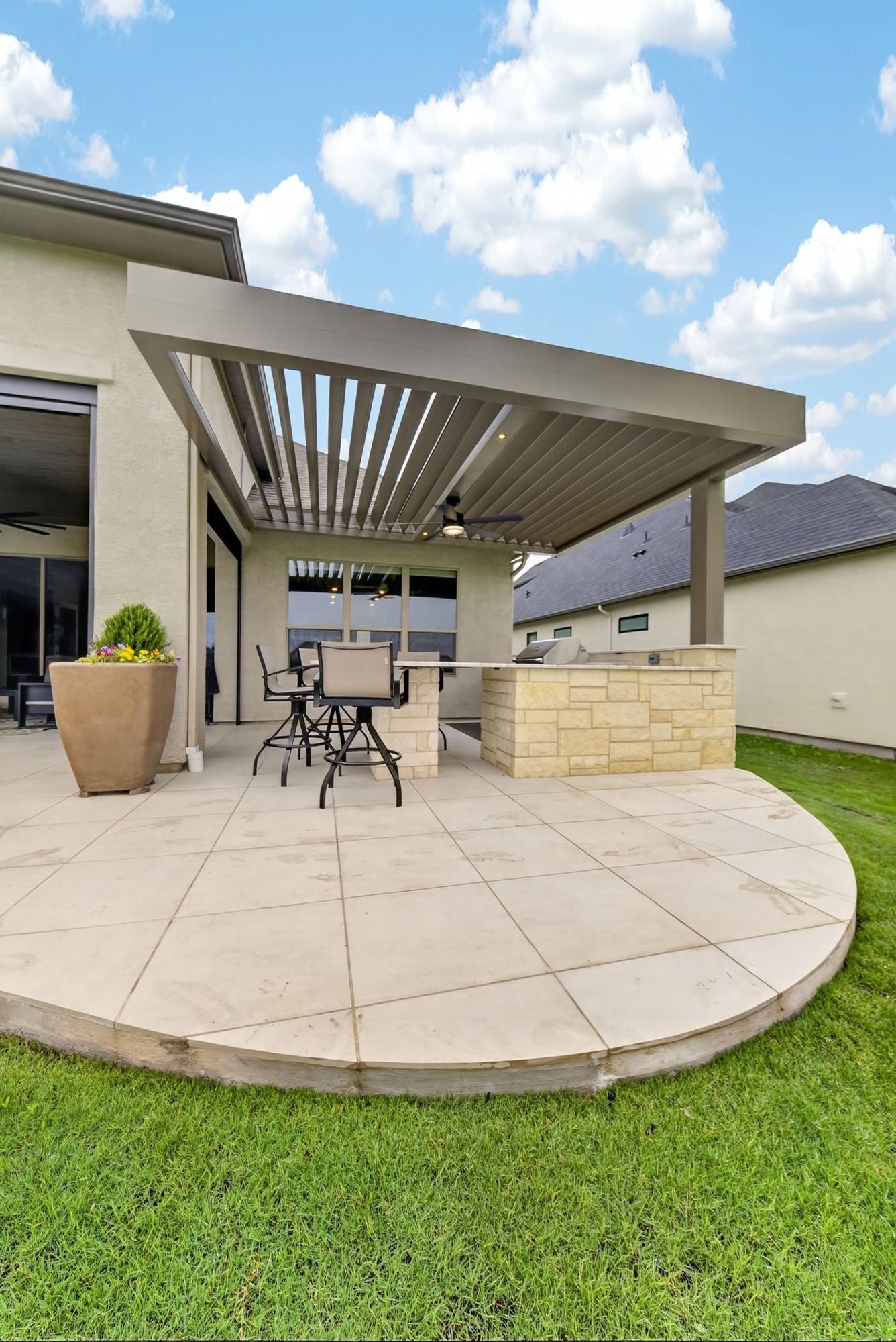 Denton motorized louvered pergola with outdoor kitchen and pool